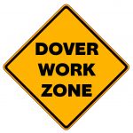 Yellow, diamond-shaped traffic sign with black text, "Dover Work Zone"