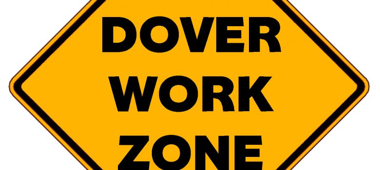 Yellow, diamond-shaped traffic sign with black text, "Dover Work Zone"