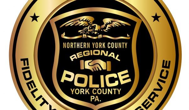 Gold circle with black shield in the middle and gold text, "Northern York County Regional Police York County PA"