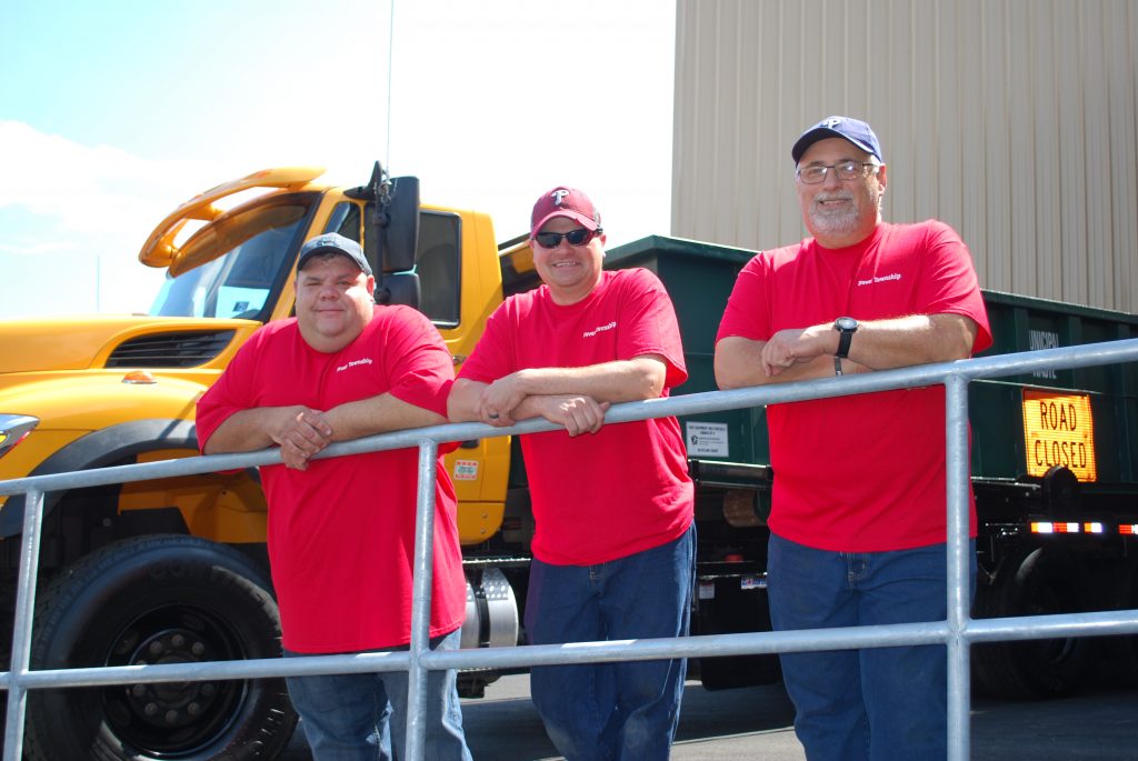 Dover Township Sewer Department group picture wearing red shirts. From left to right, Shawn Appler, Chris Hamme and Glenwood Leas.