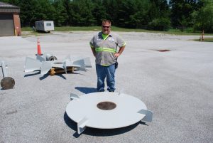 Photo 4 – Aaron standing next to mixer shaft parts to provide you an idea as to how big the equipment is.