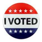 Circular button, top third is red with white stars, middle third is white with black text, "I VOTED" and the bottom third is blue with white stars